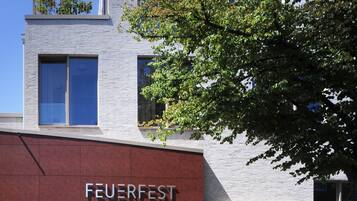 Welcome to Feuerfest, featuring a striking entrance with white brick and red panels.