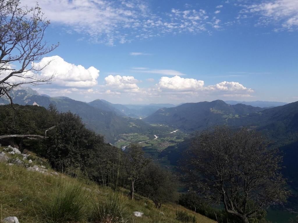 A mountainous landscape with a valley and a river.
