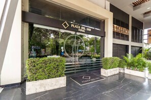 Welcome to Plaza Del Lili Hotel, where a sleek glass door and elegant entrance set the tone for a stylish stay.