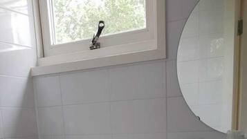 Ein Badezimmer mit Toilette, Waschbecken und Fenster.