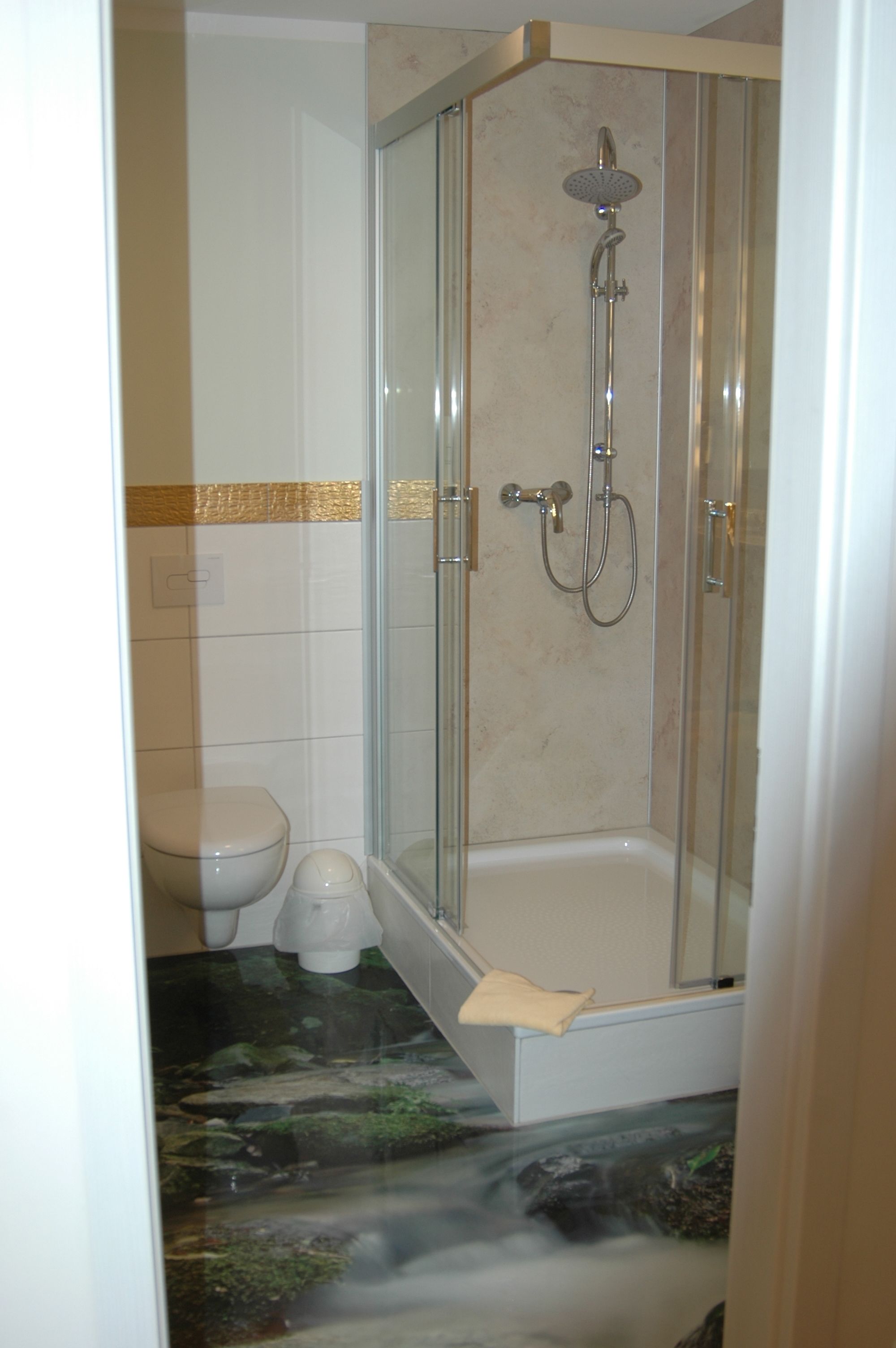 A shower with a glass door, a toilet, and a bathtub.