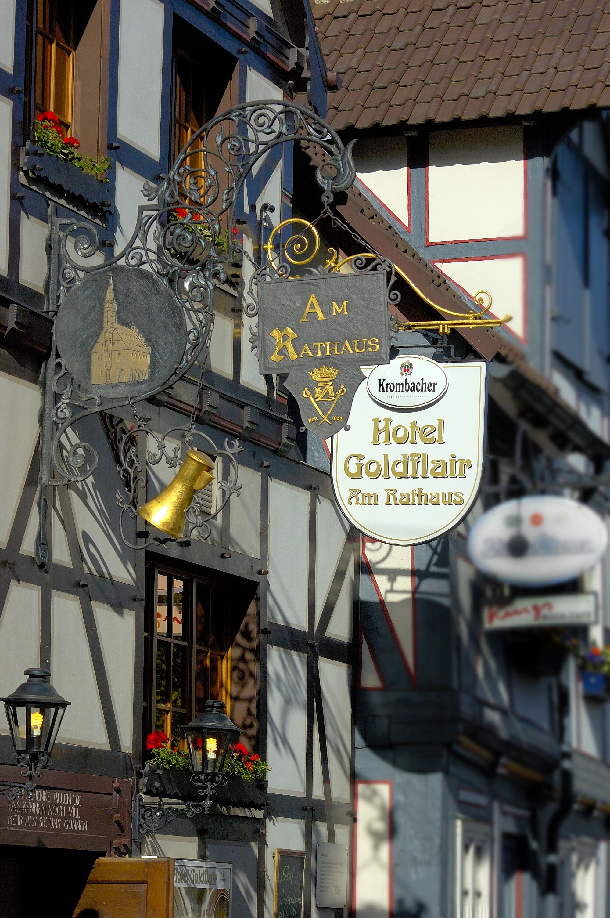A traditional European building with a sign for Hotel Goldflair.