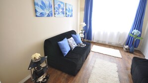Basic Apartment, 3 Bedrooms | Living room | 32-inch flat-screen TV with digital channels, TV
