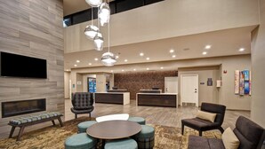 A modern lobby with a reception desk, seating area, and a fireplace. - Residence Inn by Marriott Cincinnati Northeast/Mason (Mason)