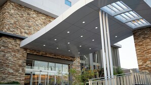 A modern building with a stone facade, large windows, and a covered entrance area. - Fairfield Inn & Suites by Marriott Mexicali (Mexicali)