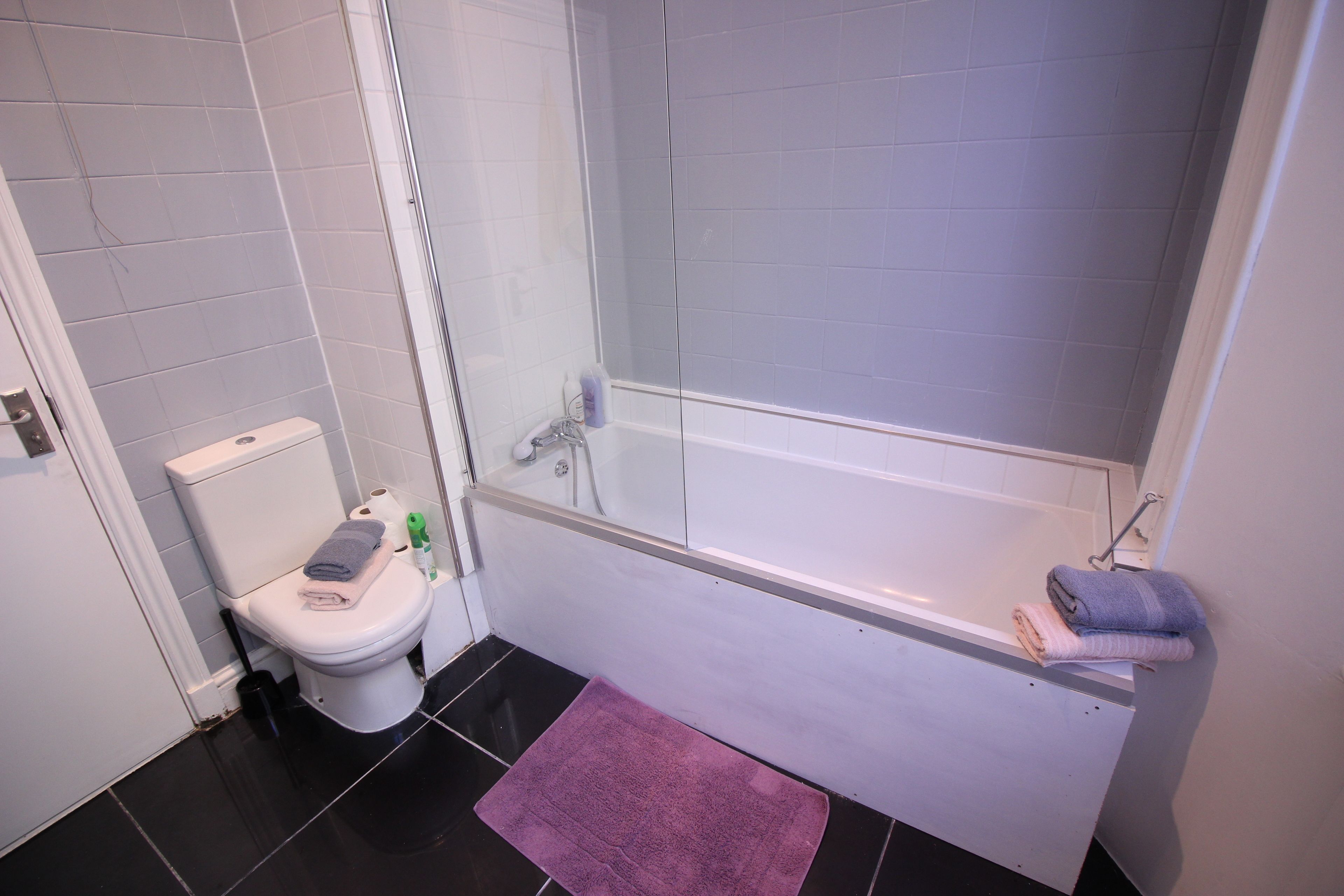 A bathroom with a toilet, a shower, and a bathtub.