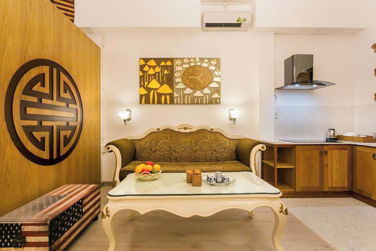 A living room with a sofa, coffee table, and wall art.