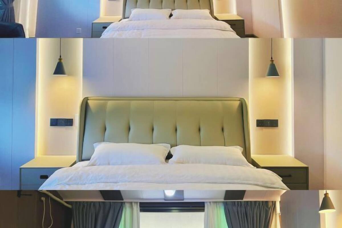 A hotel room with a large bed, two bedside tables, and wall-mounted lamps.