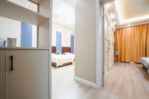 A hotel room with a bed, a wardrobe, a desk, and a bathroom. - Shangqing Hotel (Guixi)