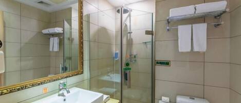 A modern bathroom with a glass-enclosed shower, a large mirror with a decorative frame, a sink with a faucet, and a towel rack with towels.