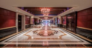 A hotel corridor with a grand chandelier, marble flooring, and a large number '5' in the center. - Jinjiang International Hotel Ganzhou (GANZHOU)