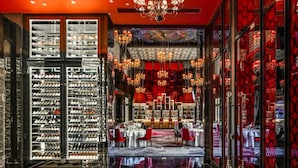 A hotel lobby with a checkered floor, wine racks, a dining area, and a chandelier. - Jinjiang International Hotel Ganzhou (GANZHOU)