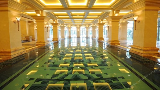 A spacious indoor swimming pool with a geometric tile pattern, surrounded by columns and recessed lighting. - Jinjiang International Hotel Ganzhou (GANZHOU)