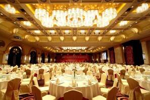 A banquet hall with round tables, white tablecloths, and chairs. - Jinjiang International Hotel Ganzhou (GANZHOU)