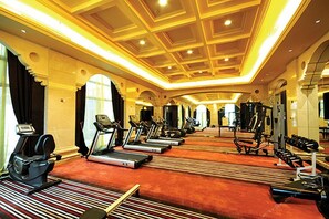 A hotel gym with treadmills, stationary bikes, and weight machines. - Jinjiang International Hotel Ganzhou (GANZHOU)