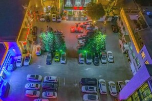 An aerial view of a parking lot with cars and trees. - Suzhou Hotel (Jiuquan)