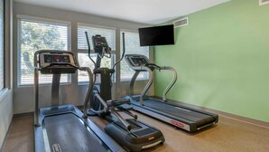 A fitness room with treadmills, a stationary bike, and a rowing machine. - Extended Stay America Suites - Portland - East (Portland)