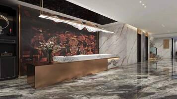 Experience the sleek lobby with a central reception desk, vibrant mural, and polished floor.