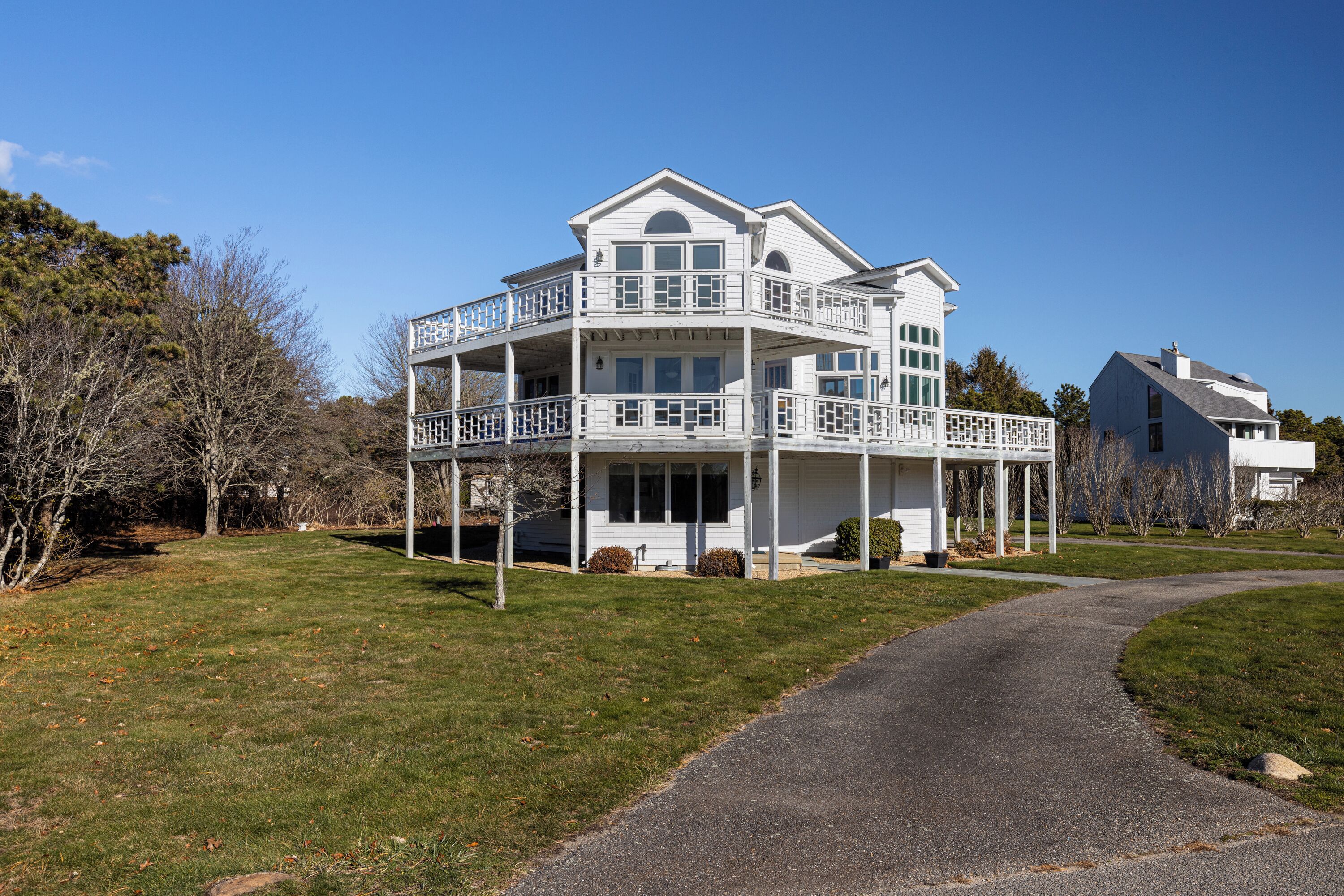 A two-story house with a balcony and a covered porch.