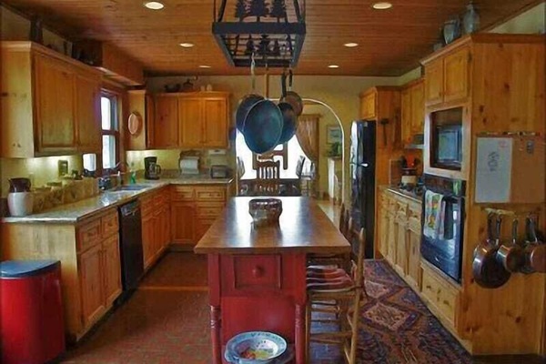 A very open Kitchen with Granite Counters, Gas Range & Butcher Block Island.