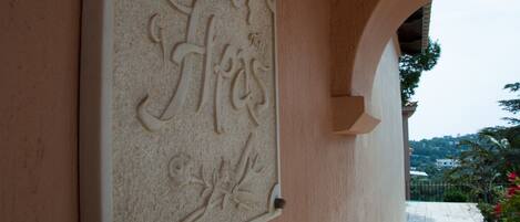 Un mur orné de sculptures et d’inscriptions, ainsi qu’une plaque de pierre.