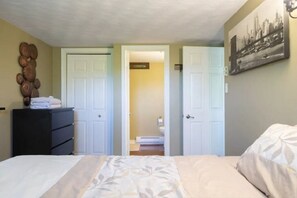Comfortable accommodations feature a bed, dresser, and bathroom with a sink and mirror.