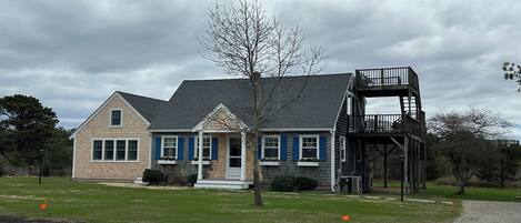 A two-story house with a balcony and a small porch.