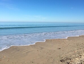 Enjoy a serene beach experience with access to the calm sea and soft sand.