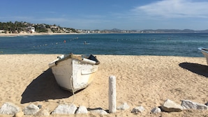 A beach with a boat on the sand and a clear view of the sea and distant hills. -  Near the best Surf beaches in San Jose del Cabo! (San José del Cabo)