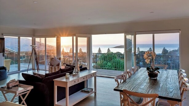 A spacious living area with a large wooden table and chairs, a sofa, and a tripod. - Uninterrupted Views Encounter Bay (Encounter Bay)