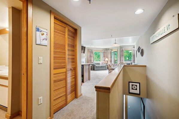 A hallway leading to a dining area with a view of the outdoors. - 2-bedroom condo with mountain views, pool, and hot tub. (Killington)