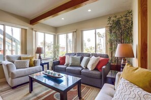 A living room with a sofa set, a coffee table, and a lamp.