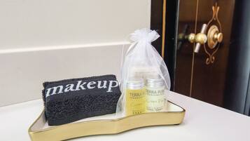 A tray with a black towel and two bottles of Terra Pure shampoo and conditioner.