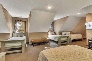A bedroom with two beds, a bench, and a small table. - Secluded 40 Acres Near Table Rock, Stunning Views, Games, Community Pool & Car Charger (Blue Eye)