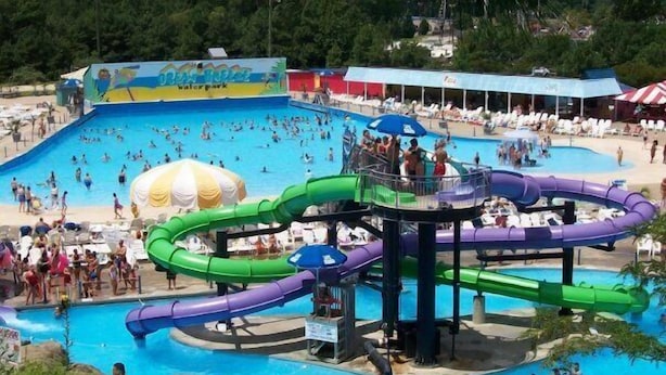 A water park with multiple slides and a large swimming pool. - Great Location ! 1 Short Block To The Boardwalk. (Virginia Beach)