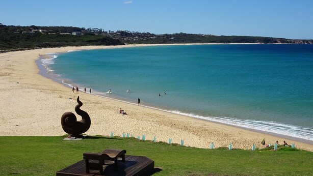 A beach with a spiral sculpture and a wooden deck. - Tura Views, 3 BR House (Tura Beach, Merimbula)