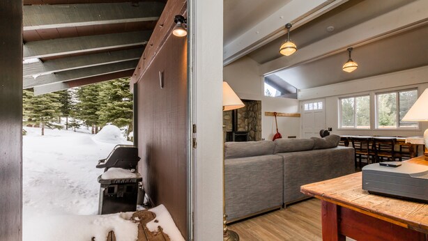 A cozy living area with a gray sofa, wooden coffee table, and pendant lights. - Lily Pad_Modern w/ AC! + Games, Smart TV's & HOA Amenities (Gym/HotTub/Sauna/Pool) (Truckee)