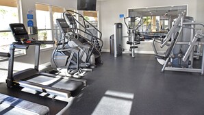 A gym with treadmills, weight machines, and a television screen. - Newly Updated, 6BR Villa, South Facing Pool, Free water park (Kissimmee)
