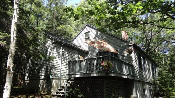 A wooden cabin with a balcony, surrounded by trees and a stone pathway. - Mount Desert Island, Bar Harbor, Acadia National Park (Bar Harbor)
