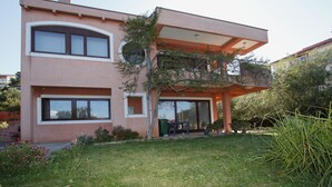 A modern two-story house with a balcony, large windows, and a well-maintained garden. - Family-friendly apartment in old fishermen village close to Zadar (Kali)