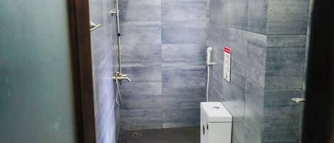 A small bathroom with a shower, toilet, and sink.