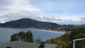 A coastal landscape with a view of the sea, a beach, and a mountain range. - Paku Paradise, Tairua. (Tairua)