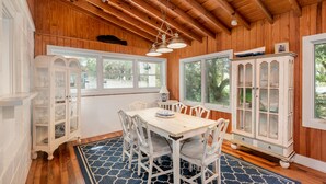 A dining area with a wooden ceiling, white cabinetry, and a table with chairs. - Private Home Located Two Blocks from Restaurants/Shops & 1 Street From Beach! (Folly Beach)