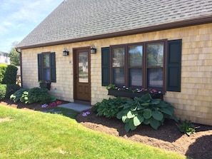 front of house with flower window boxes