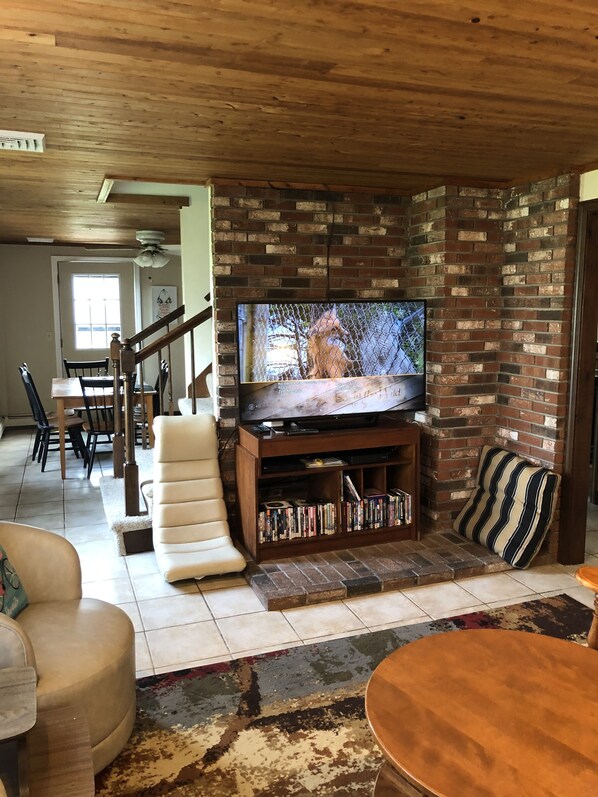 Relax in this inviting living room with a brick wall, flat-screen TV, and comfortable seating area.