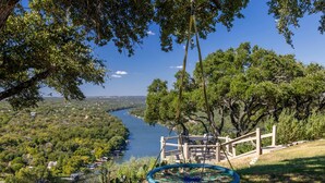 A scenic overlook with a river view, a wooden staircase, and a hammock. - Pool + Cabana + Amazing Views - Picturesque Point (Austin)