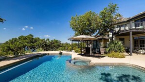A swimming pool with a hot tub, surrounded by a patio with outdoor furniture and a large tree. - Pool + Cabana + Amazing Views - Picturesque Point (Austin)