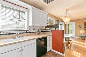 Enjoy cooking in this well-lit kitchen with a dishwasher and large island.