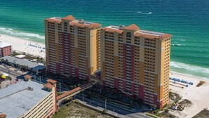 A high-rise hotel with multiple balconies overlooking a beach. - Calypso 6th floor with Gulf Master - Beach Chairs & FREE Activities each day! (Panama City Beach)