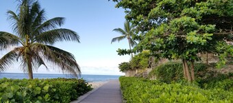 Beautiful Condo with breezy Balcony Overlooking Pool & Garden – Steps to Beach